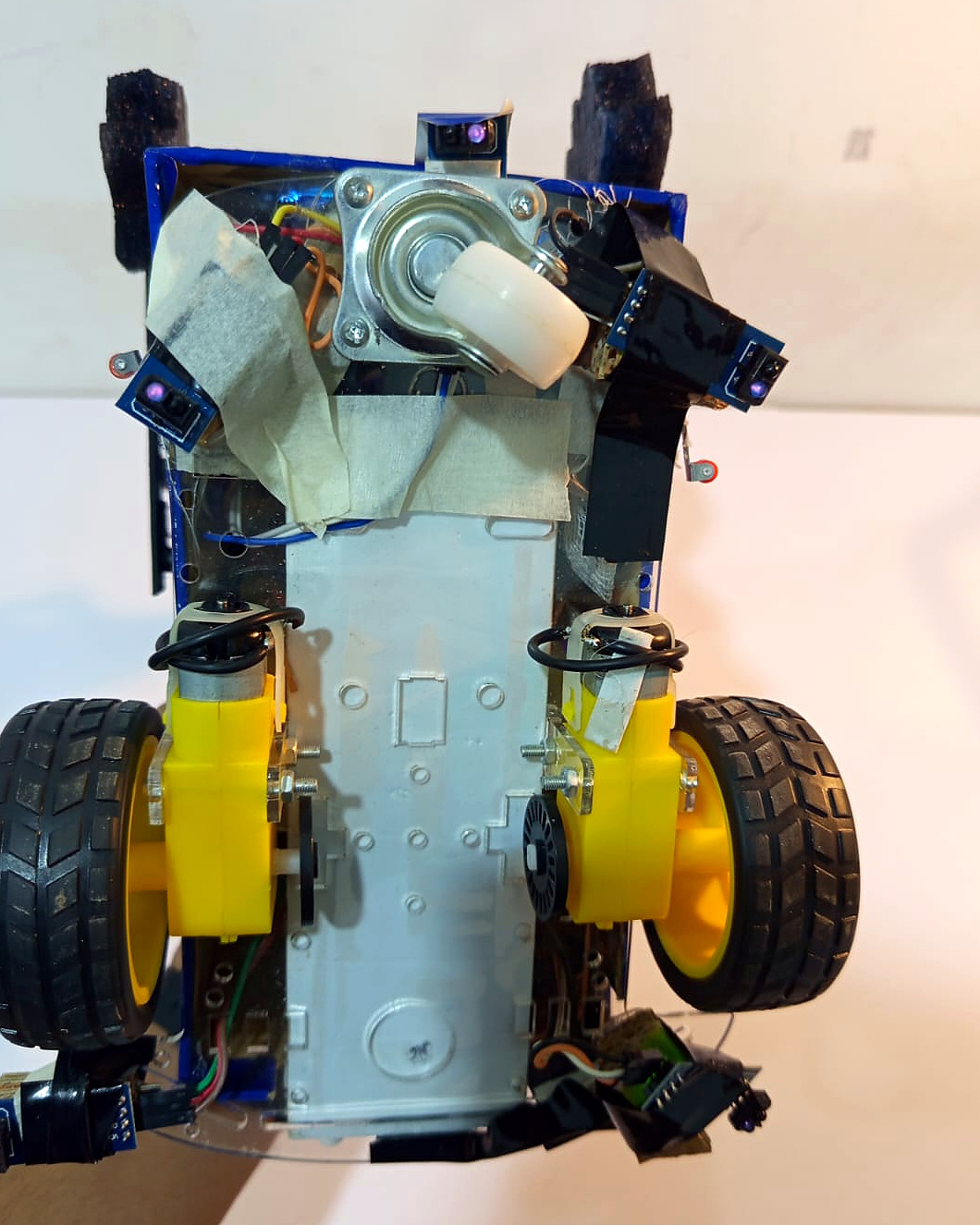 Underside of AMSAN showing its wheels, motors, caster and physical sensor hardware.